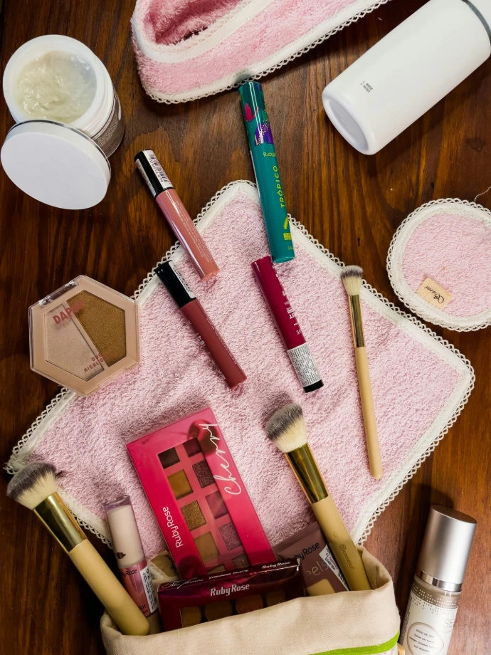 a wooden table topped with cosmetics and other items